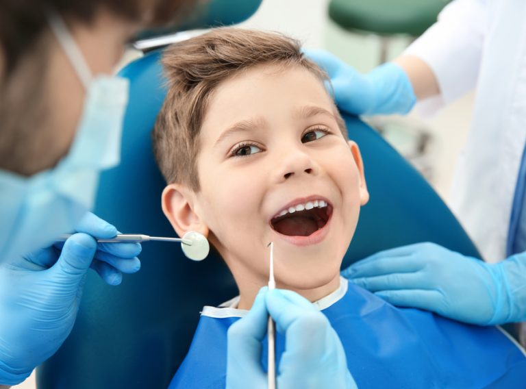 Dentist,Examining,Little,Boy's,Teeth,In,Clinic